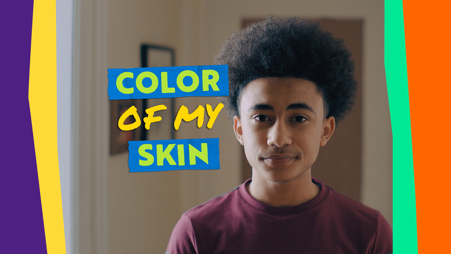 Title: Color of my Skin. An African-American boy in a red shirt looks at the camera.