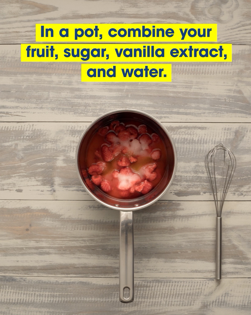 A saucepan full of red berries and other ingredients, alongside a whisk. Text: In a pot, combine your fruit, sugar, vanilla extract, and water.